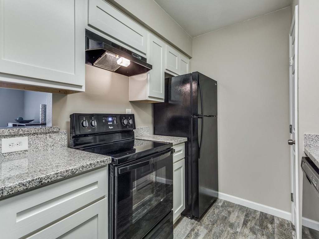 black appliances and white cabinets in the kitchen