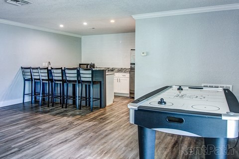 a kitchen with a stove and a table with chairs
