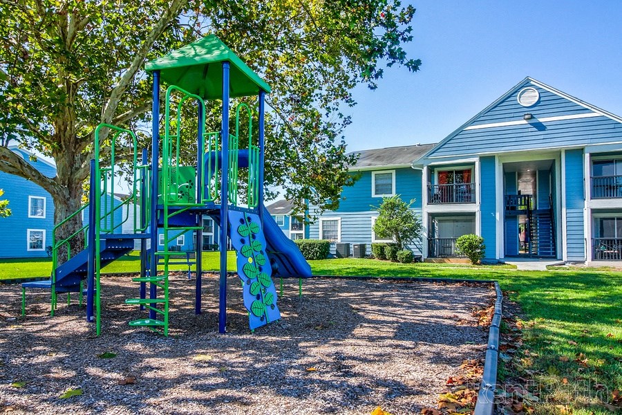 Playground area with swings and slides at The Commons apartments in Tampa, FL near downtown Tampa