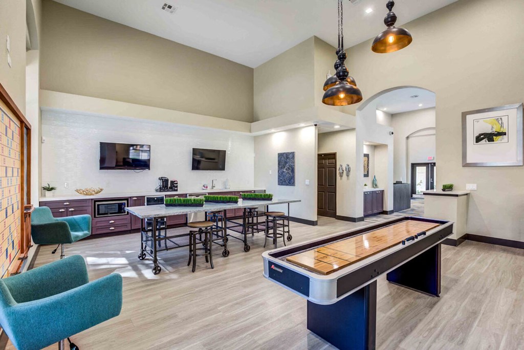 a game room with tables and chairs and a pool table
