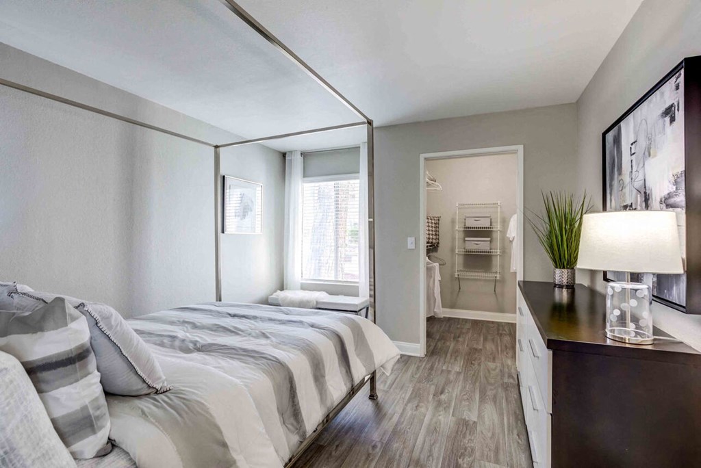 a bedroom with a large bed and a mirror