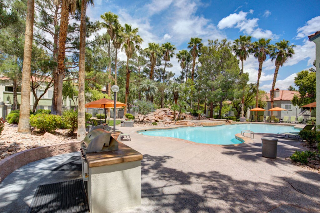 a swimming pool with trees and palm trees