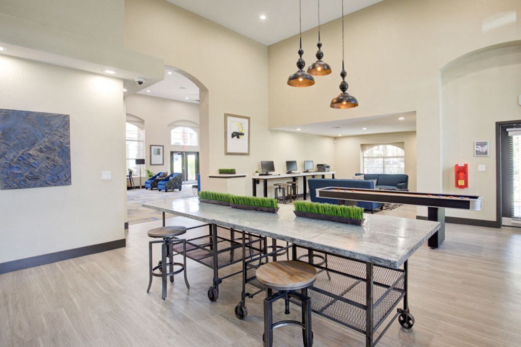 a communal area with a ping pong table and chairs