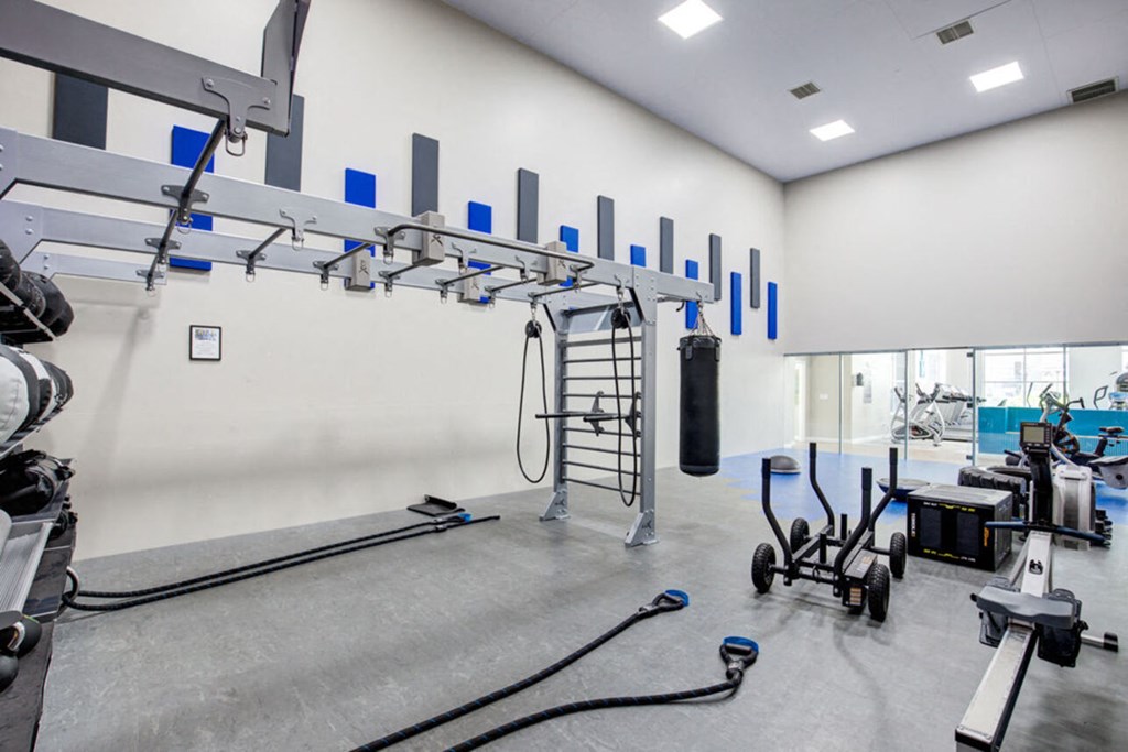 the gym atrium with weights and exercise equipment at the case building apartments