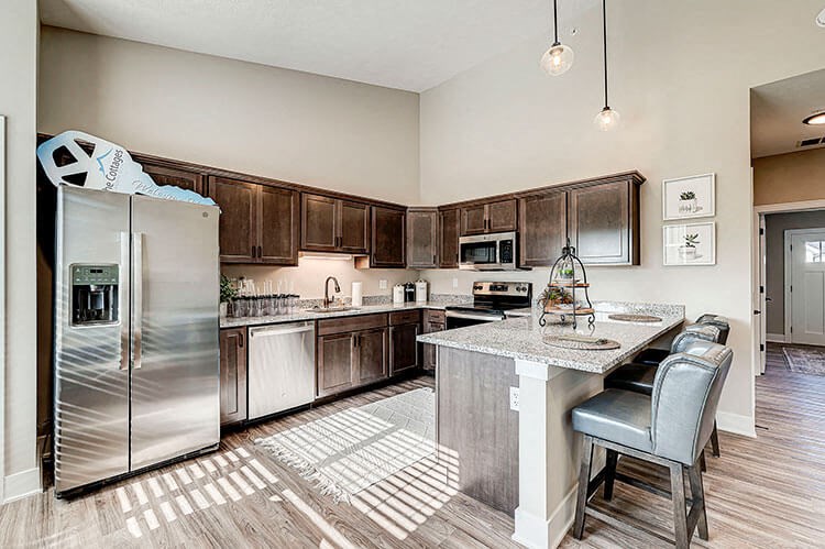 a kitchen with a large island and stainless steel appliances