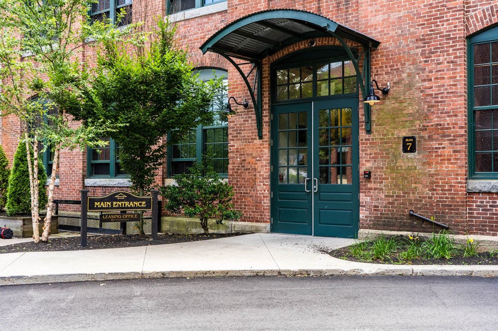 the entrance to a brick building with a green door