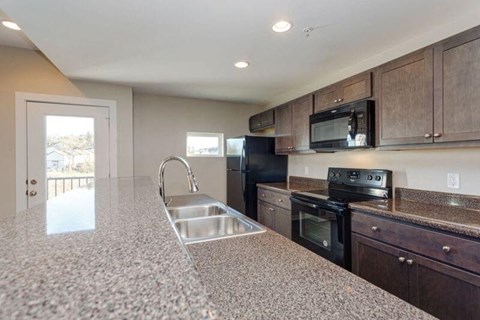 a kitchen with a sink and a stove