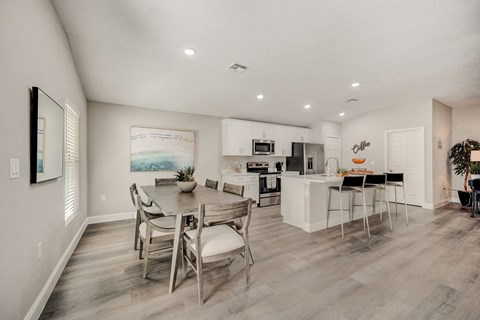 a kitchen and dining room with a table and chairs