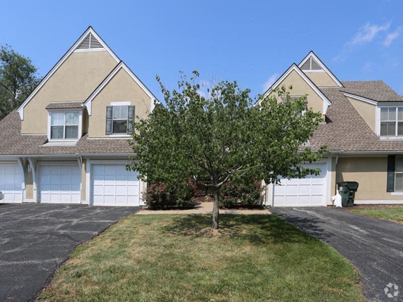 a house with a tree in the front yard