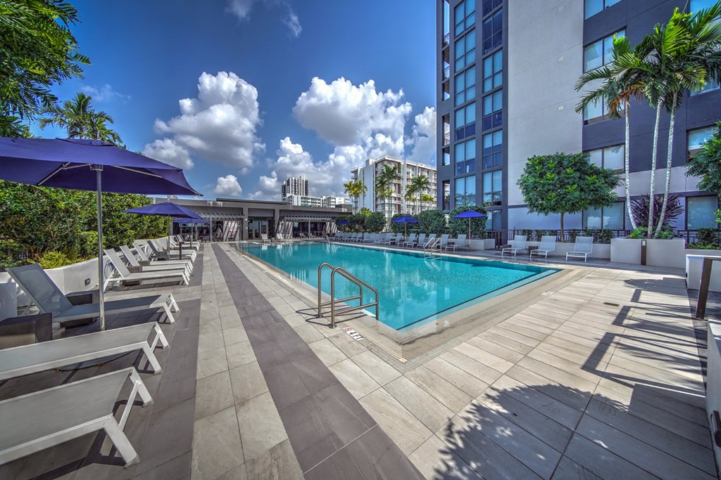a swimming pool in front of a tall building