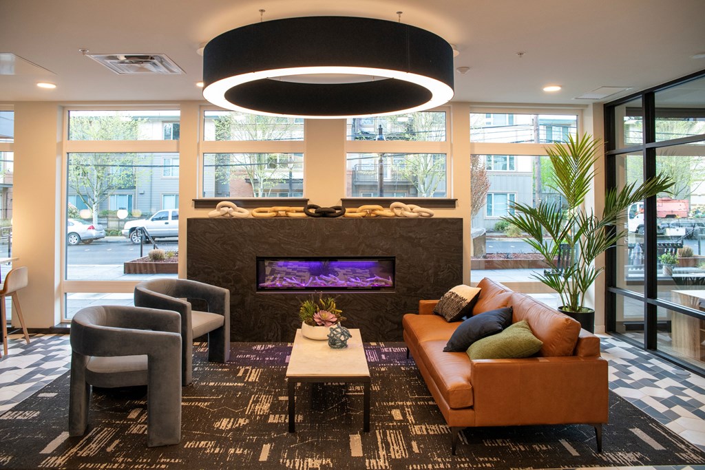a living room with couches and chairs in front of a fireplace