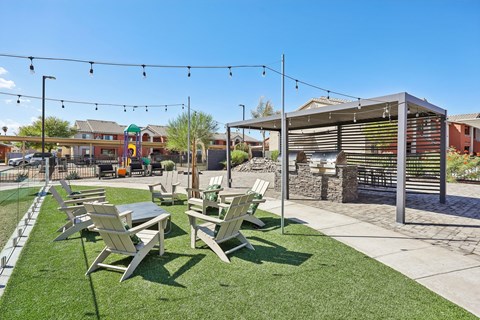 A sunny day at the park with tables and chairs set up for outdoor seating.