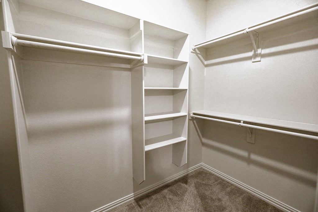 a walk in closet at the enclave at woodbridge apartments in sugar land, tx