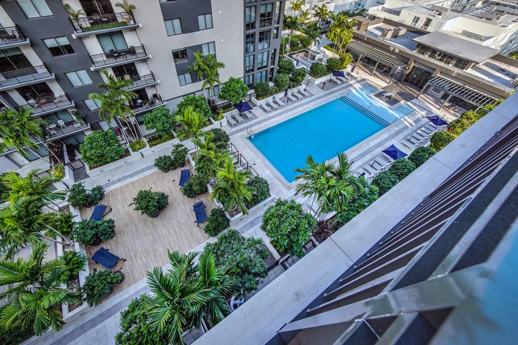 an overhead view of a pool in an apartment building