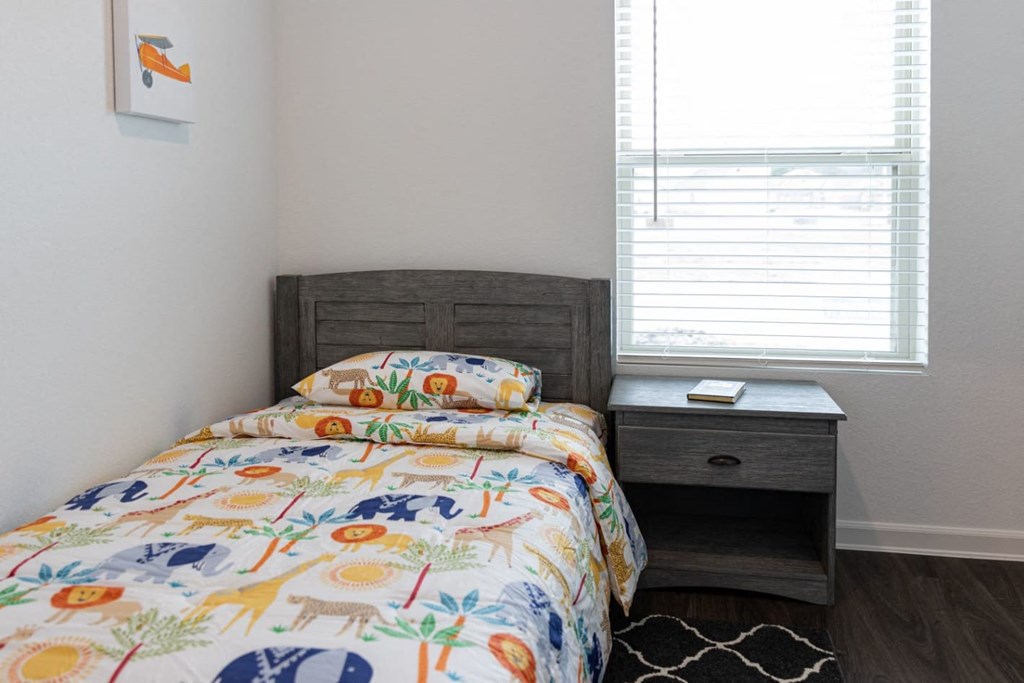 a bedroom with a bed and a window