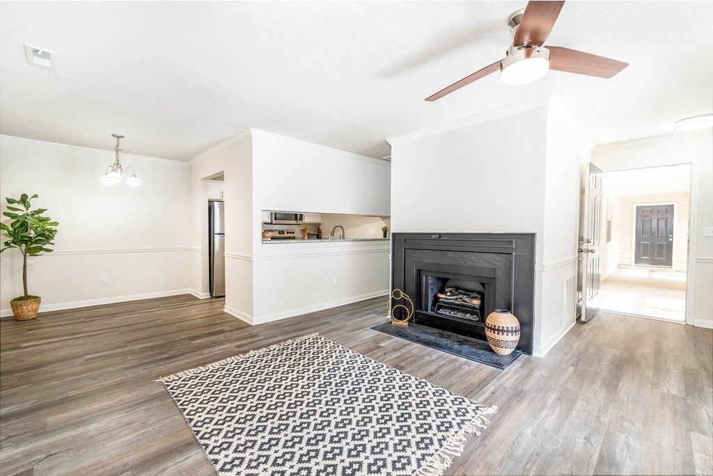 a living room with a fireplace and a rug