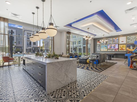 A modern kitchen with a marble island and patterned tiles.