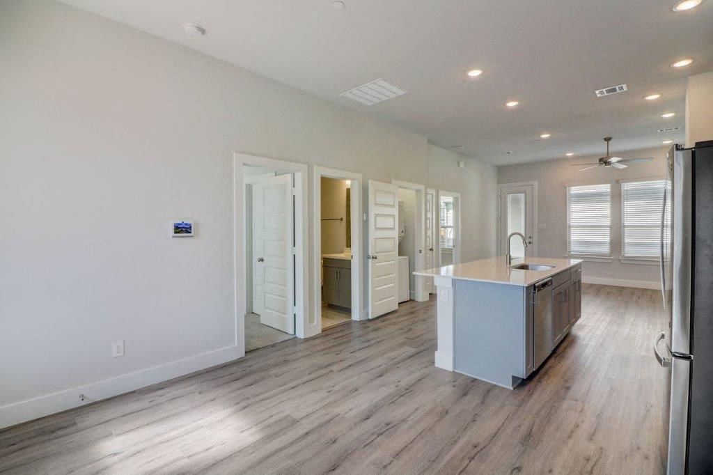 the kitchen and living room of a new home with a counter top