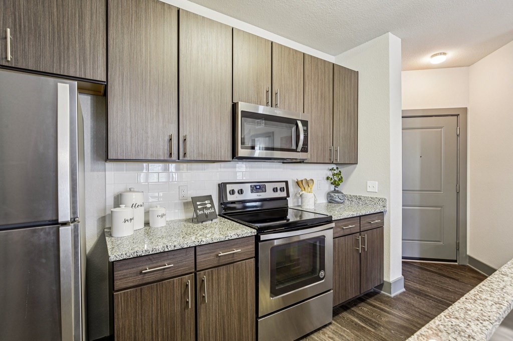 A kitchen with wooden cabinets and stainless steel appliances.