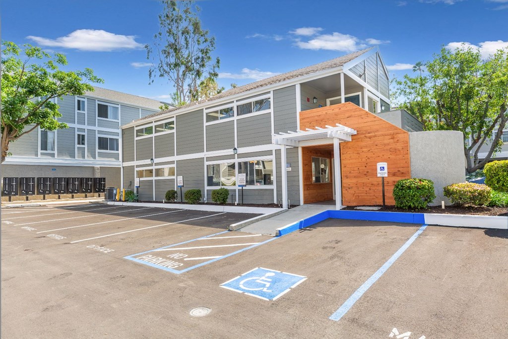 a parking lot in front of a building with handicapped parking spaces