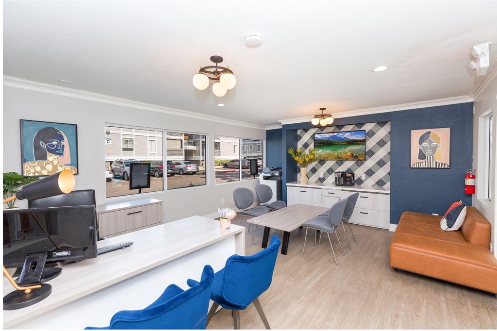 a living room with blue walls and a white table and chairs