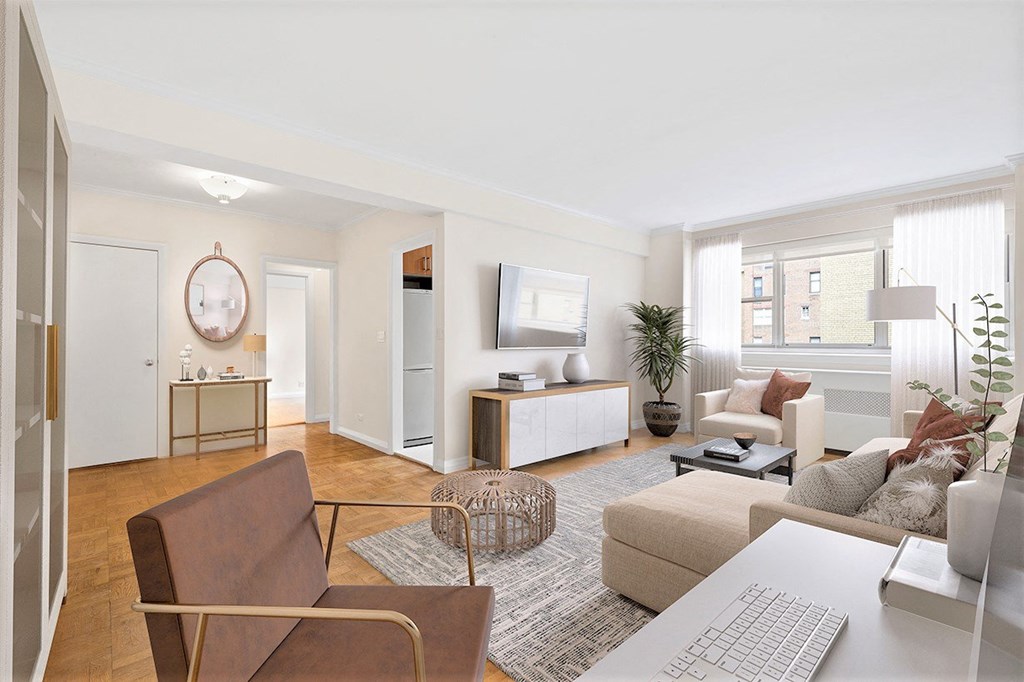 a living room with white walls and a large window