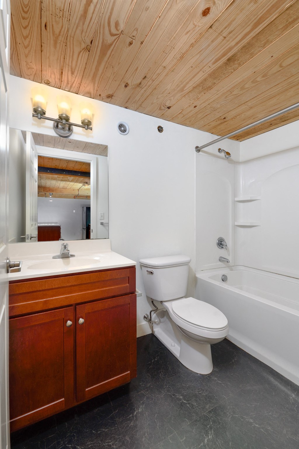 a bathroom with a toilet and a sink and a bath tub