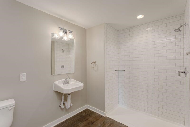 a white bathroom with a sink and a toilet
