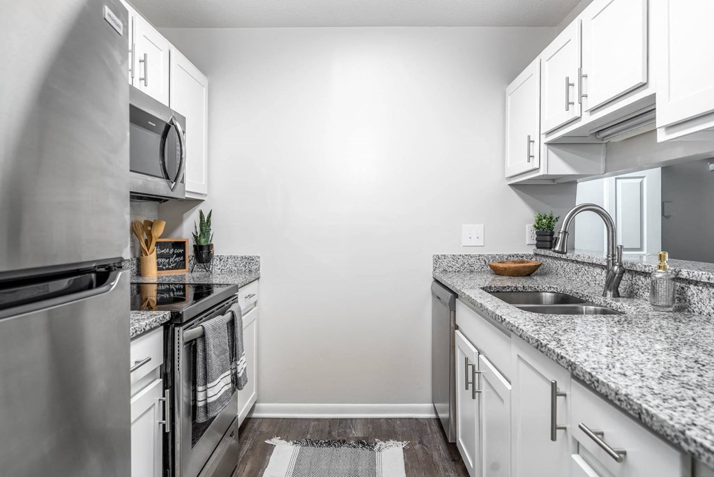 a kitchen with granite counter tops and stainless steel appliances