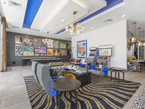A room with a blue and white striped ceiling and a black and gold rug on the floor.