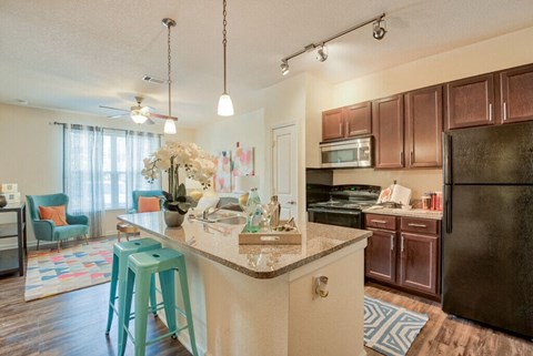 an open kitchen and living room with a counter top