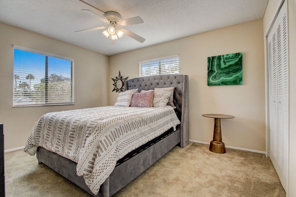 Derby Park Apartments in Daytona Beach, FL photo of the master bedroom has a comfy bed and a ceiling fan