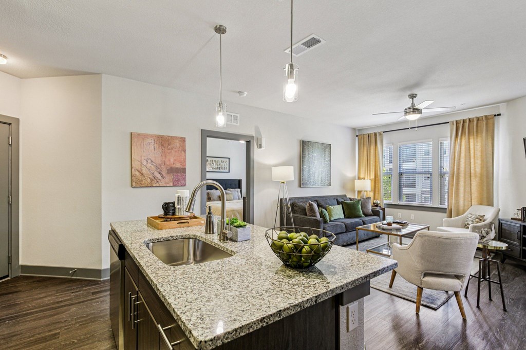 Kitchen island with granite countertop and barstools in a modern kitchen at Lotus at Starkey Ranch, Odessa, Florida.