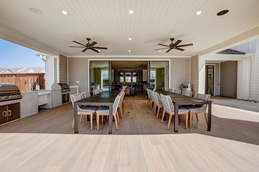 a large dining room and kitchen with a large table and chairs
