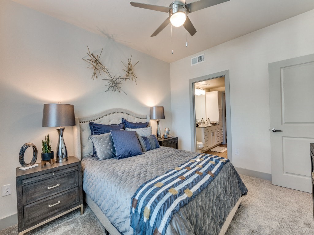 a bedroom with a bed and a ceiling fan