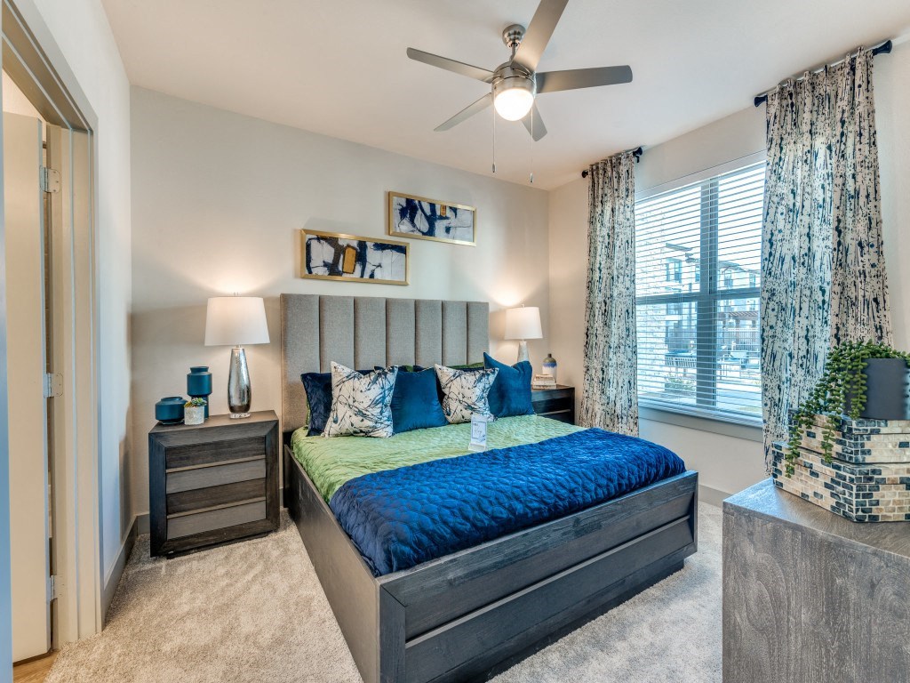 a bedroom with a bed and a ceiling fan