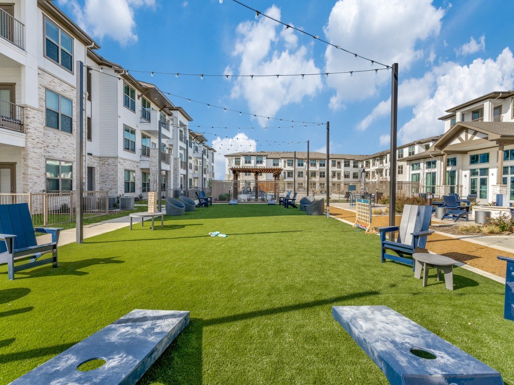 our apartments have a large yard with grass and tables