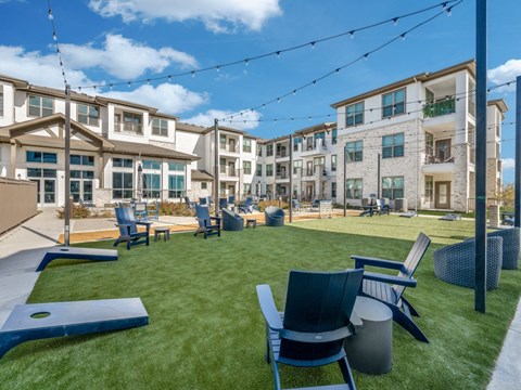 an outdoor patio with chairs and tables and buildings