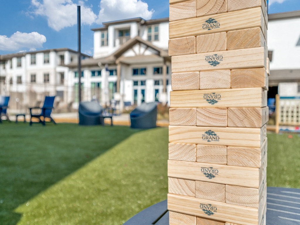 a block of wood with a house in the background