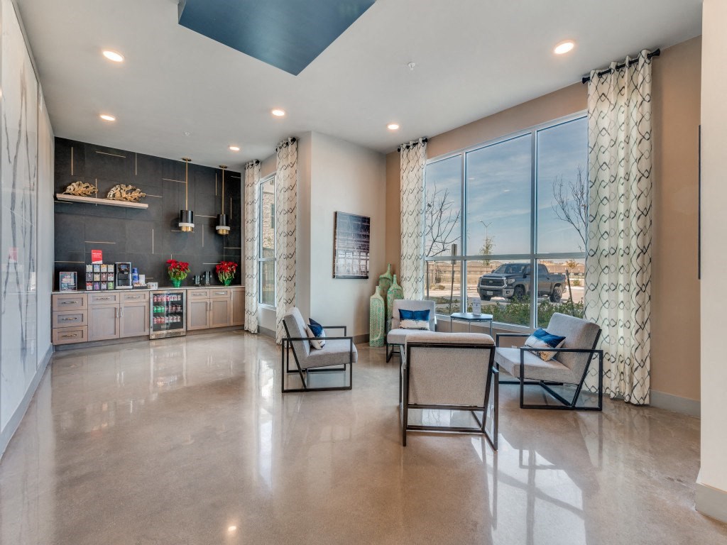 a living room with a table and chairs and a large window