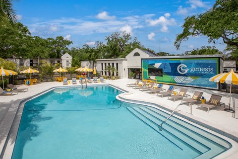A large swimming pool with a Genesis sign in the background.