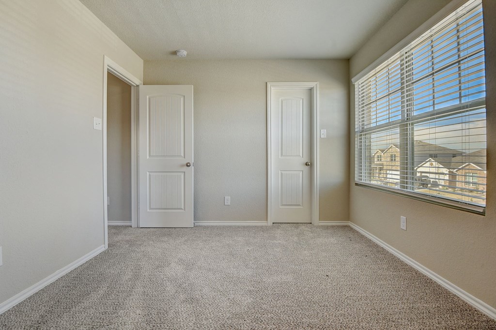 an empty living room with a large window