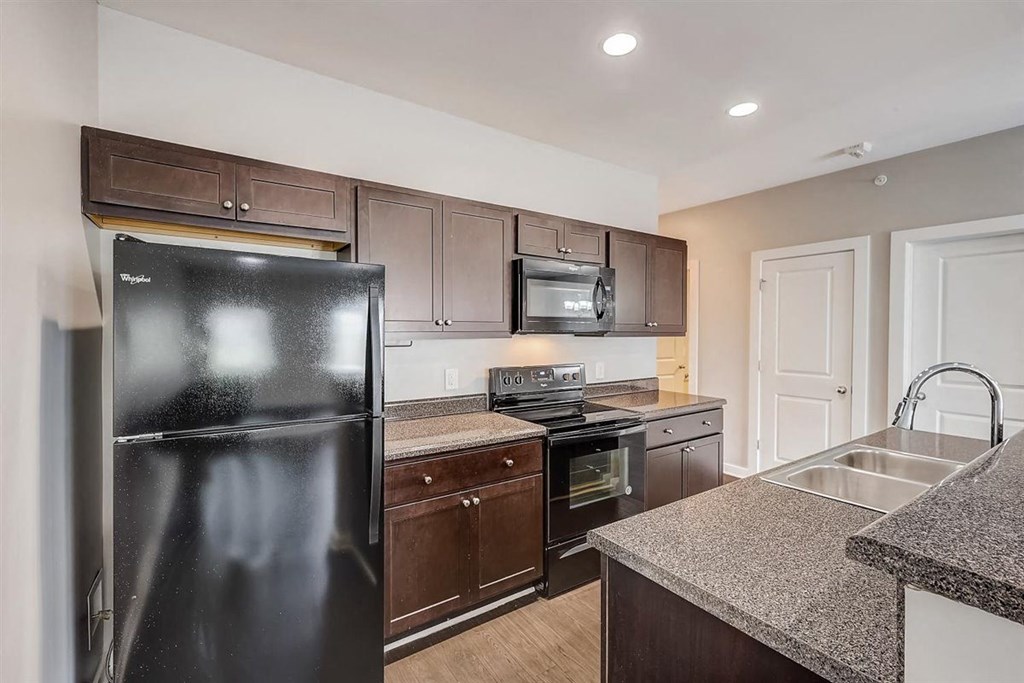 a kitchen with black appliances and granite countertops