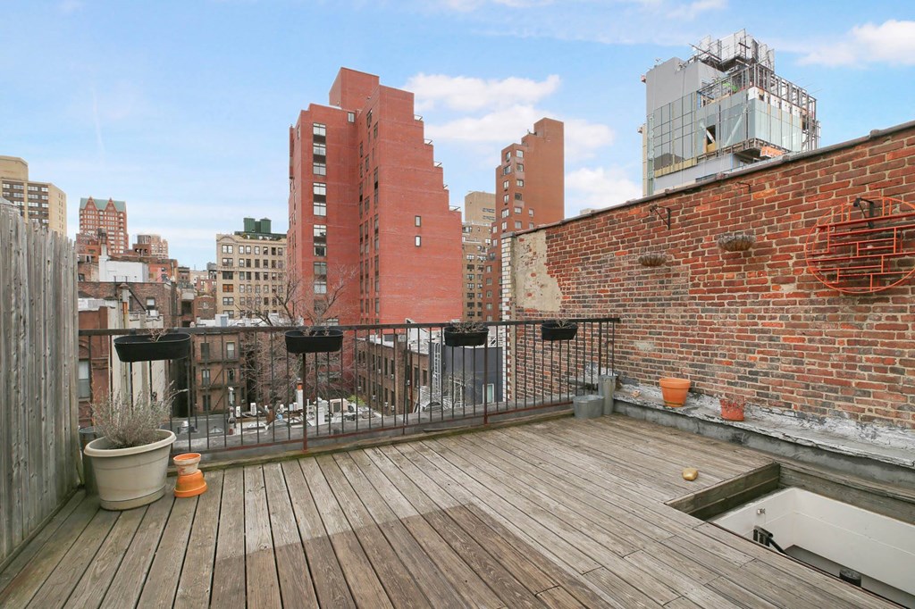 the roof deck has views of the city and a hot tub