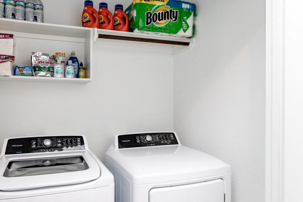 a white washer and dryer sit next to each other in a laundry room