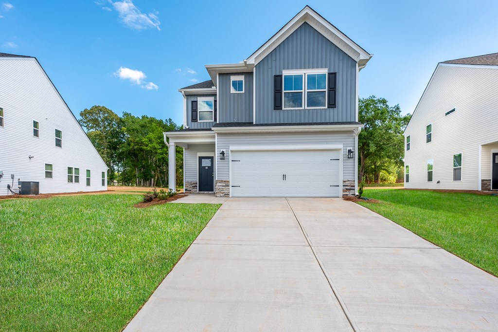 a house with a white garage door and a driveway