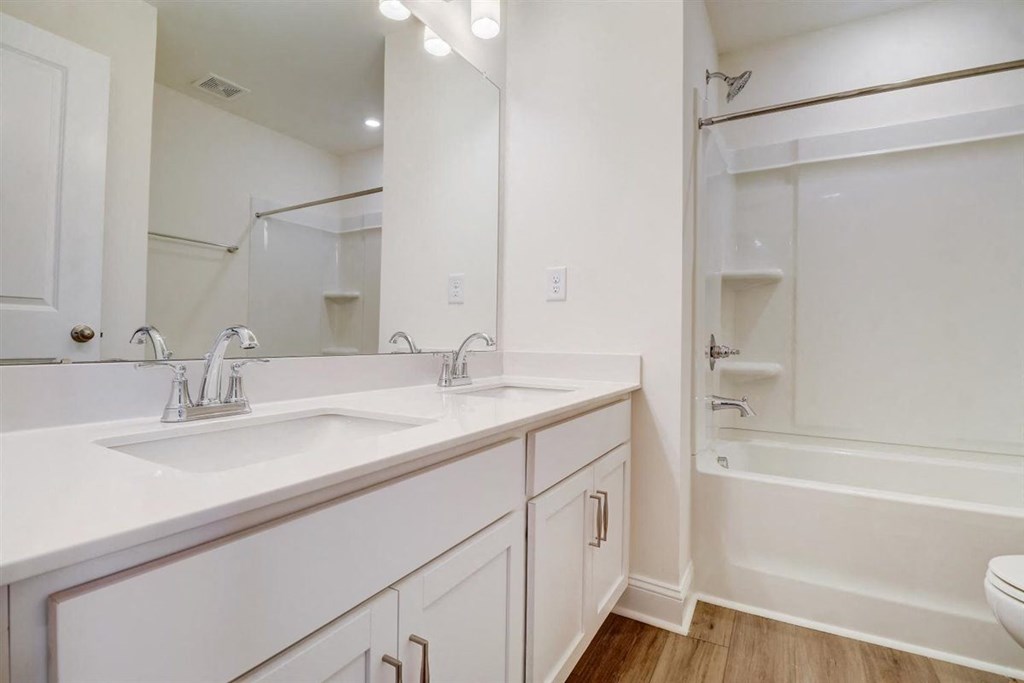 a bathroom with two sinks and a bathtub