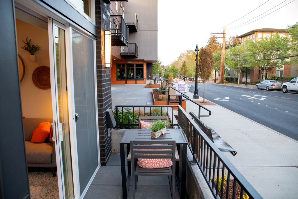 a small patio with a table and chairs on a balcony