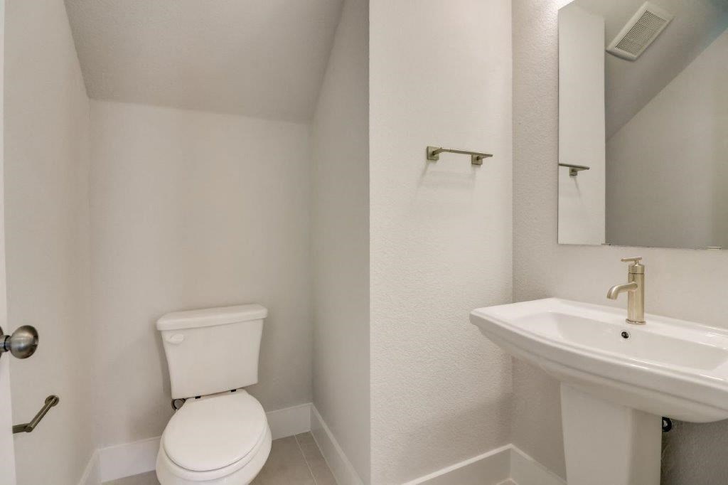 a white bathroom with a sink and a toilet