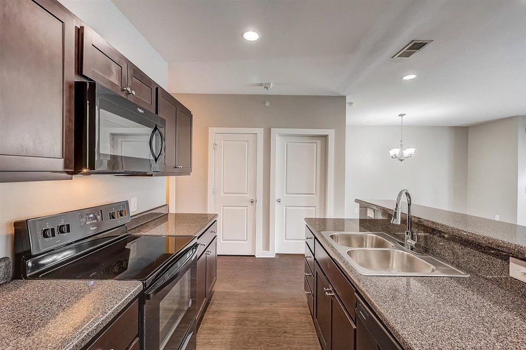 a kitchen with granite countertops and stainless steel appliances